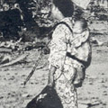 Postcard: Superimposed image of mother and child in front of the ruined 12 storey tower of Asakusa